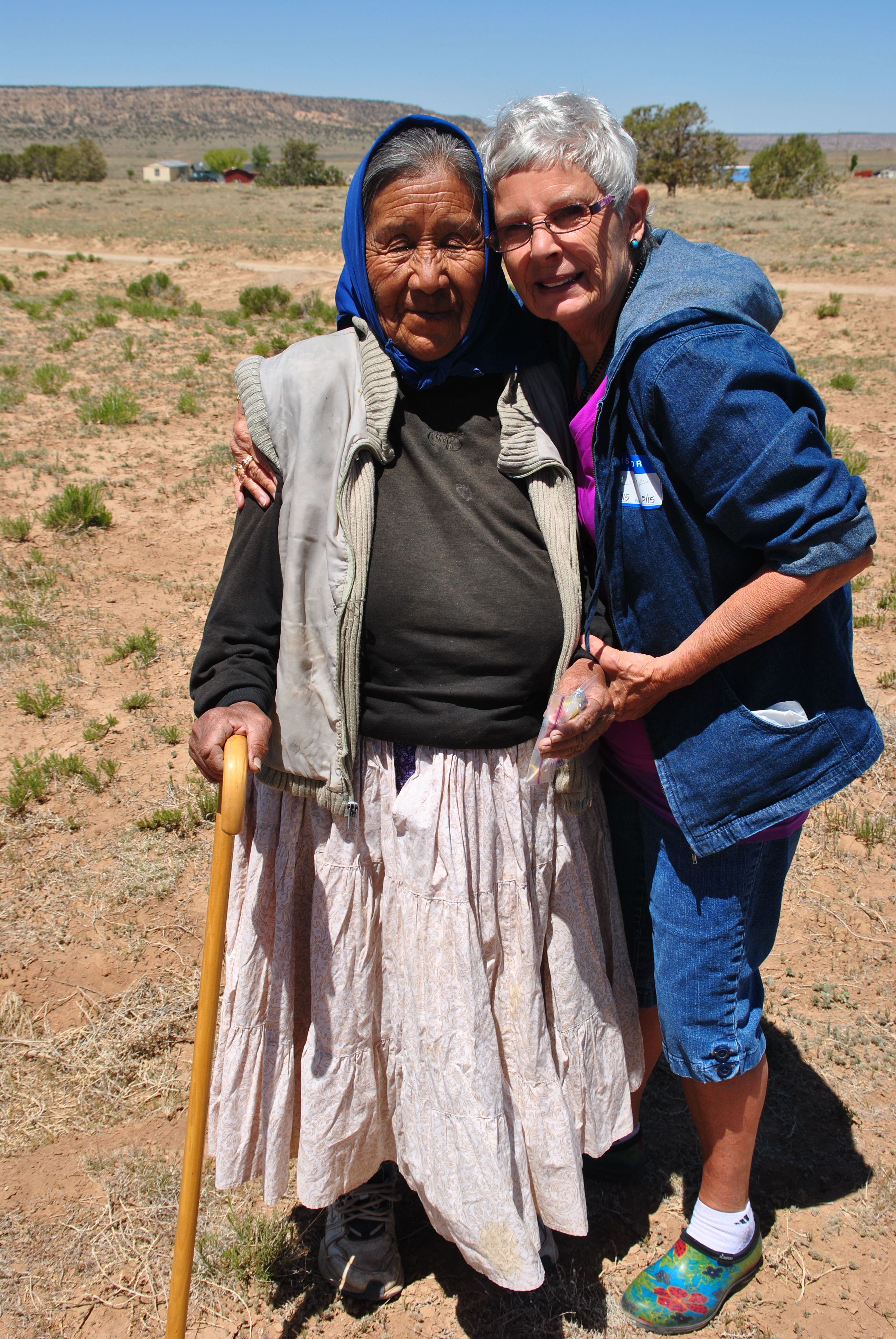 Sylvia visiting with a woman on the reservation