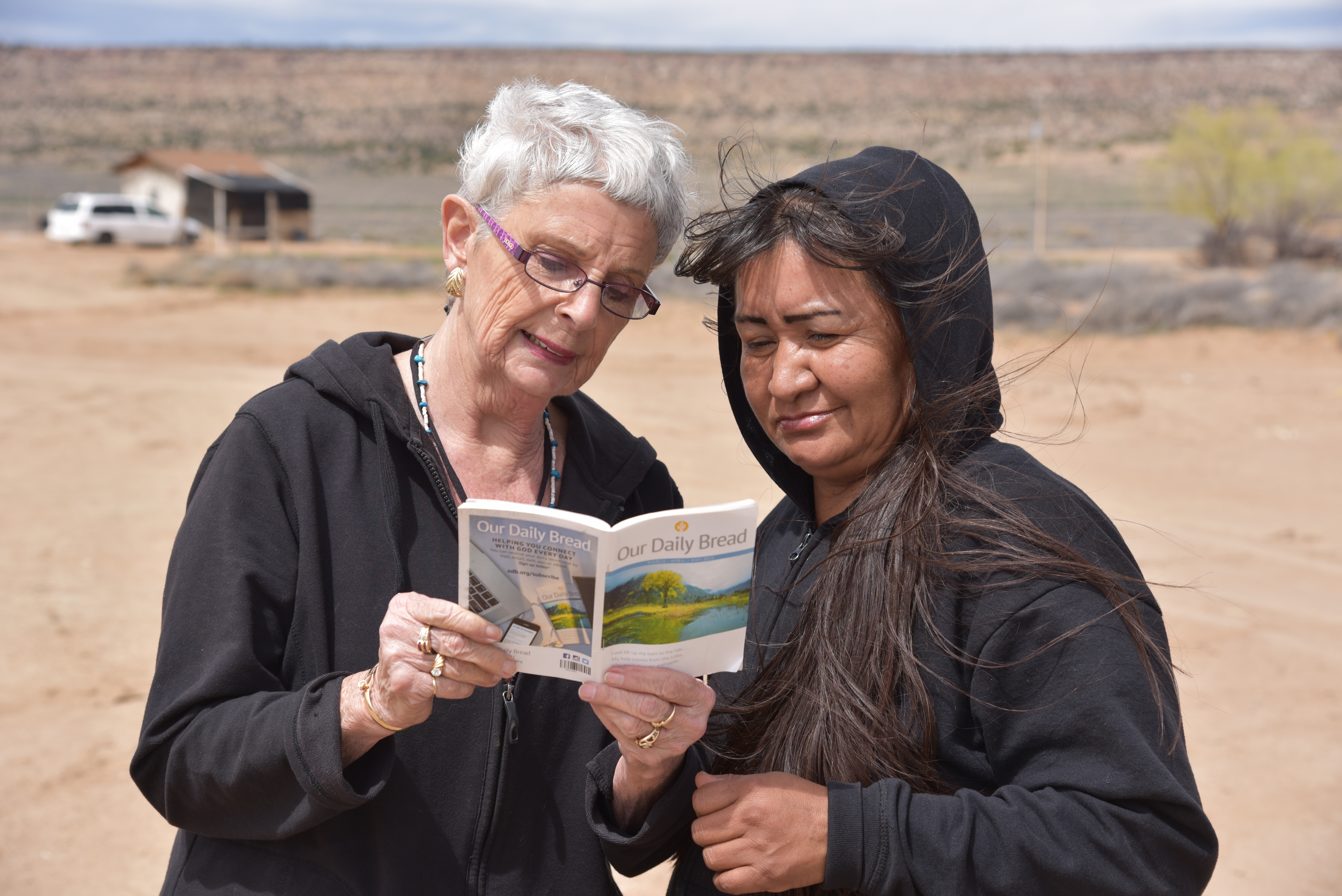 Sylvia visiting and reading Scripture with a woman